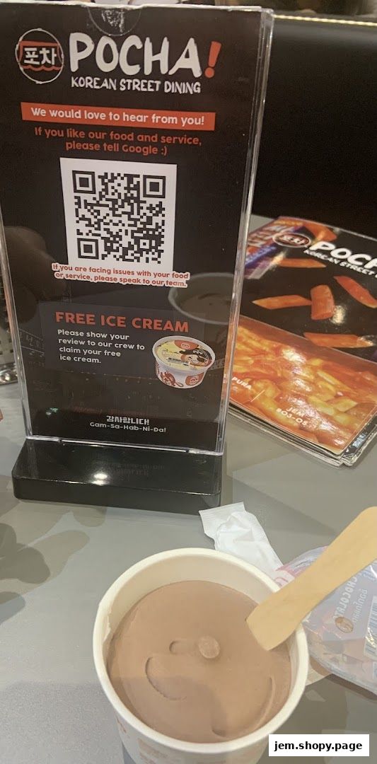 A sign offering free ice cream for reviews at POCHA! Korean Street Dining.