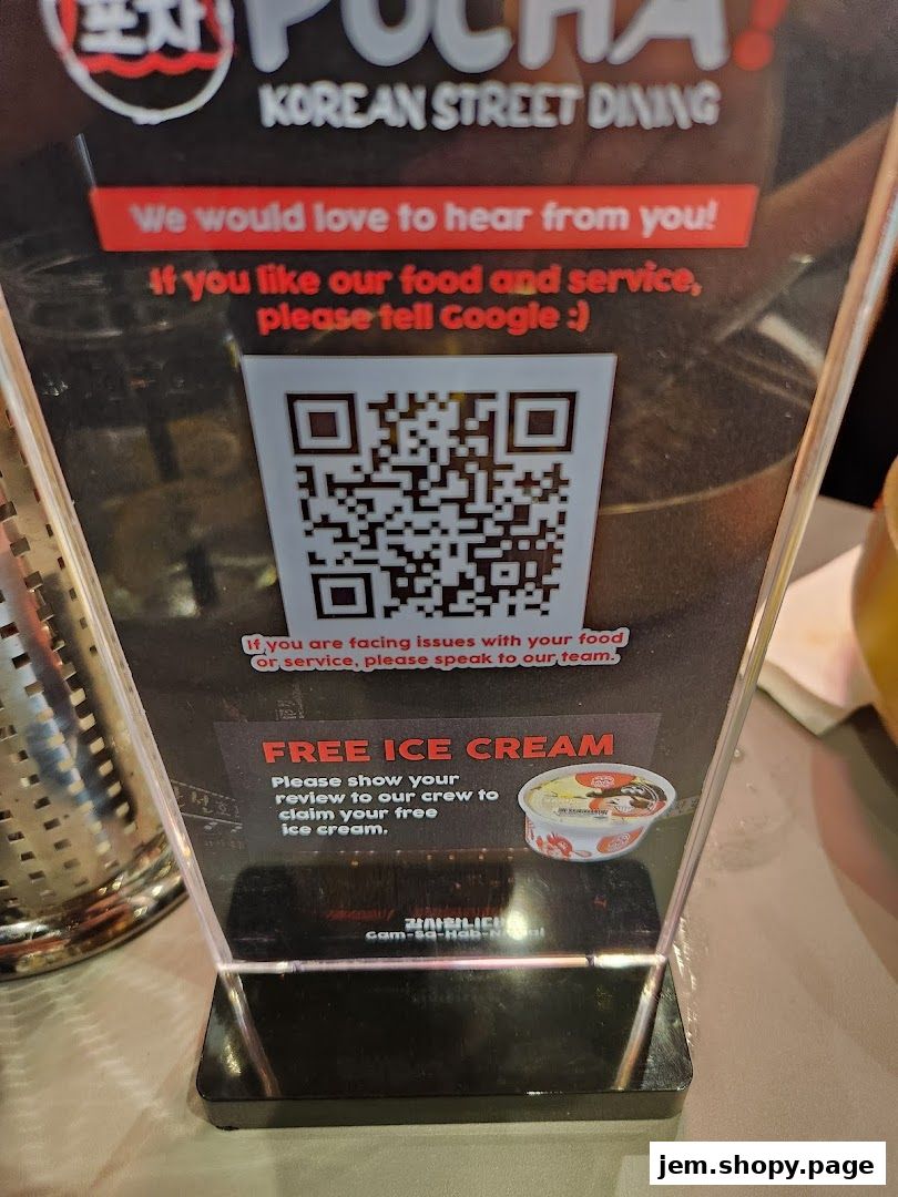 A sign at POCHA! Korean Street Dining offers free ice cream for reviews.