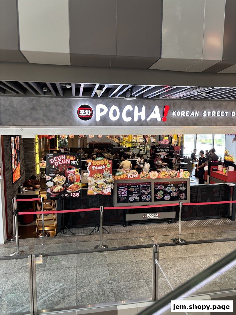 The exterior of POCHA! Korean Street Dining, showcasing its vibrant signage and menu displays.
