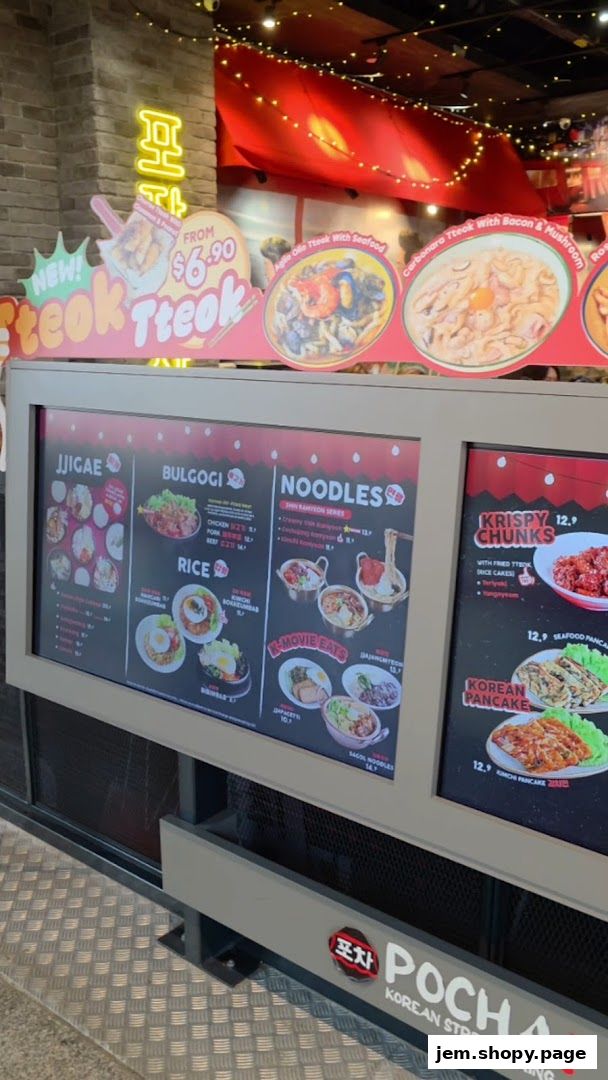 A digital menu board displays various Korean street food dishes with prices.