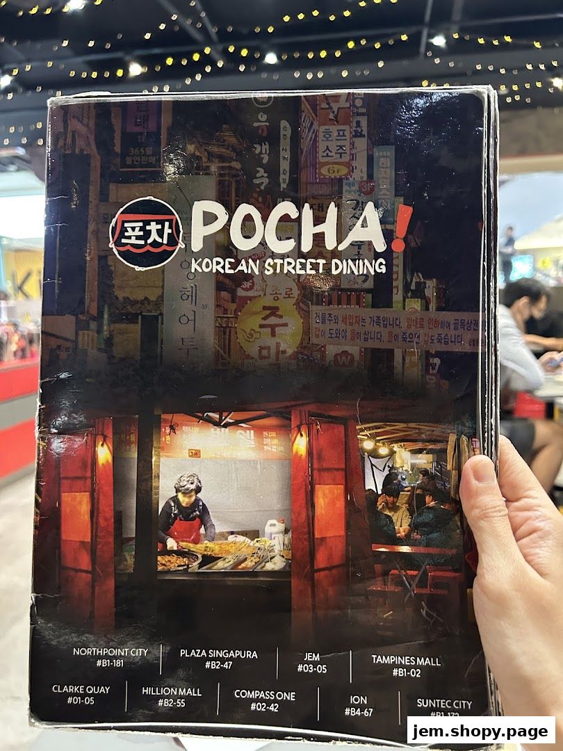A menu cover for POCHA! Korean Street Dining, featuring street scenes and restaurant locations.