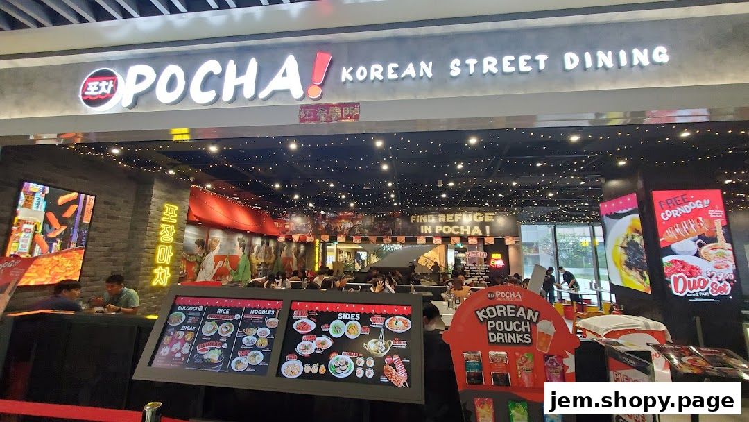 The exterior of POCHA! Korean Street Dining, showcasing its vibrant signage and menu displays.