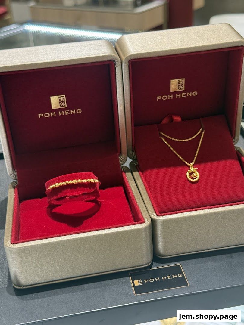 Poh Heng Jewellery displays a gold ring and a gold necklace in elegant red velvet boxes.