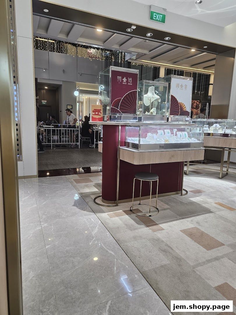 Interior view of Poh Heng Jewellery shop with display cases showcasing jewelry and a seating area.