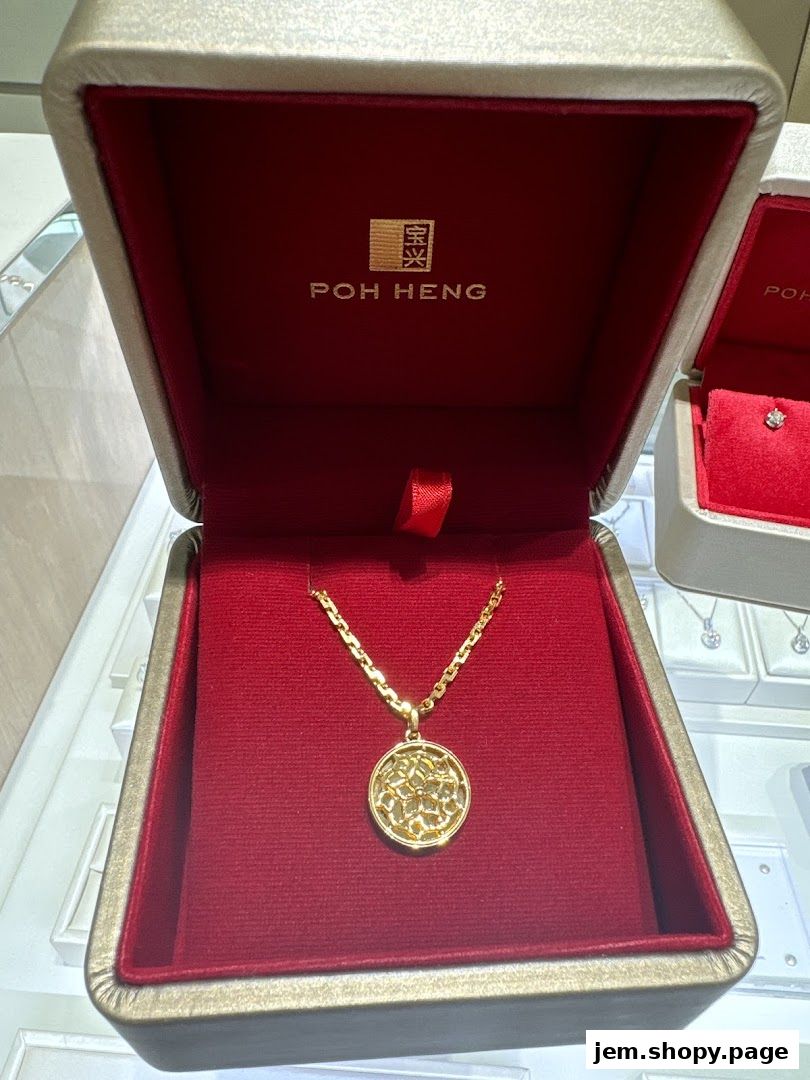 A gold pendant necklace with a floral design in a jewelry box.