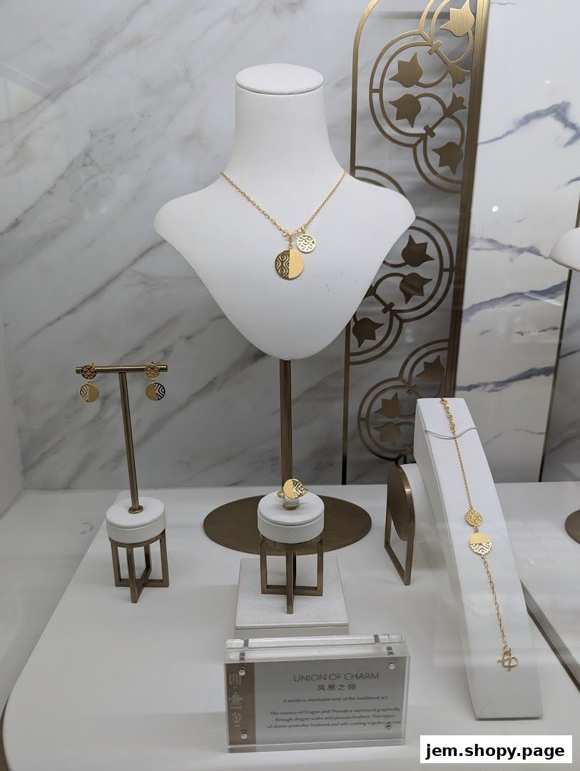 A display of elegant gold jewelry including a necklace, earrings, ring, and bracelet.
