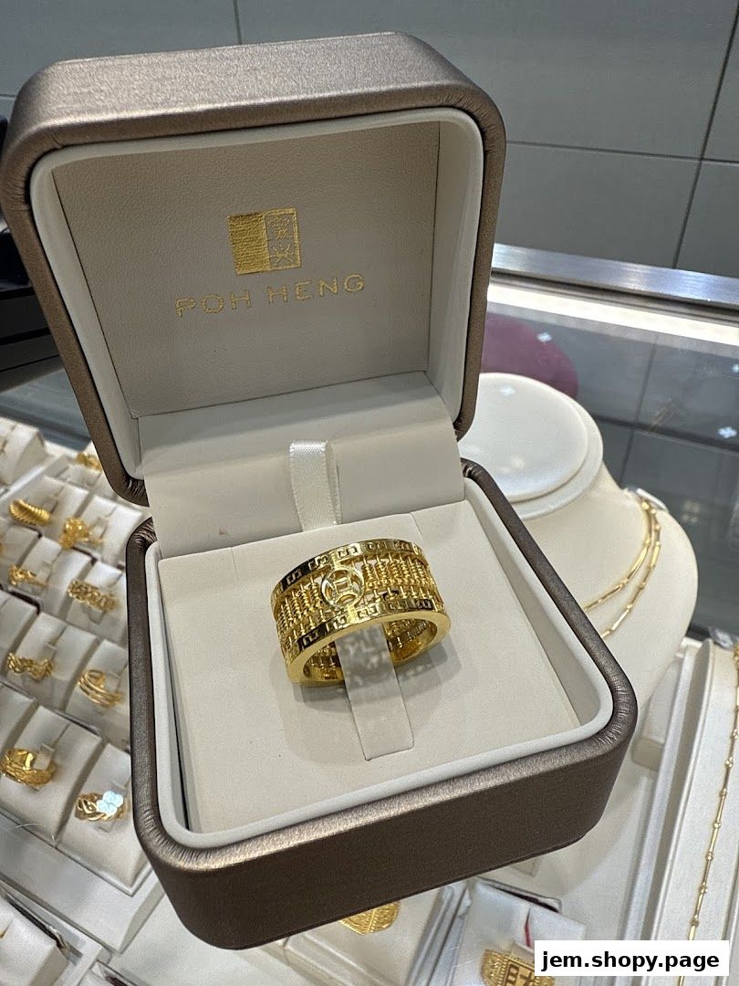 A gold ring with an abacus design displayed in a Poh Heng Jewellery box.