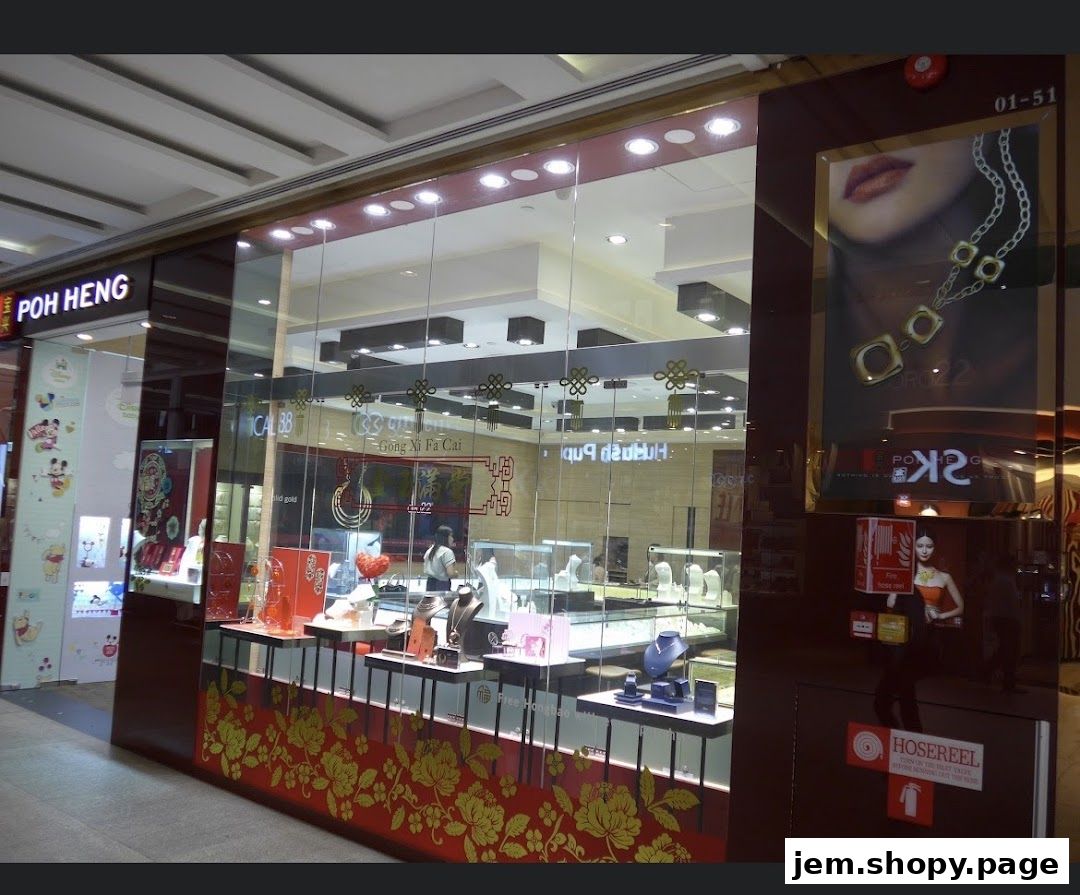 Poh Heng Jewellery store front with displays of gold jewelry and promotional posters.