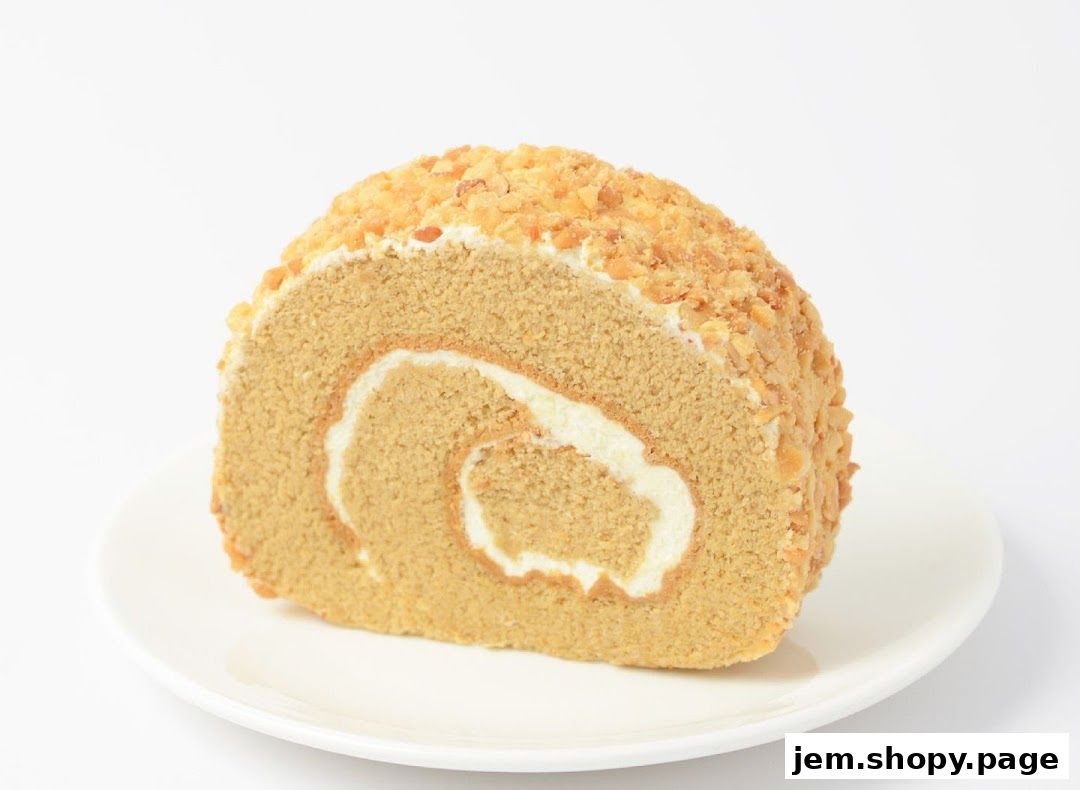 A slice of coffee-flavored swiss roll cake with cream filling and chopped nuts.