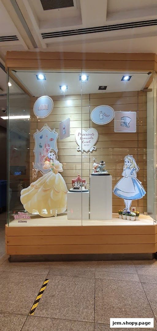 Shop window display featuring Disney Princess Belle and Alice in Wonderland characters.