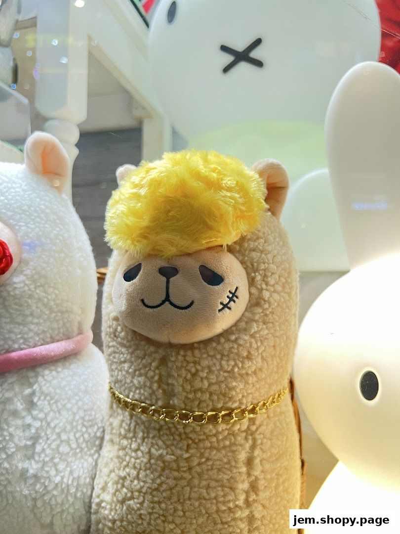 Close-up of fluffy alpaca plush toys with cute faces and accessories.