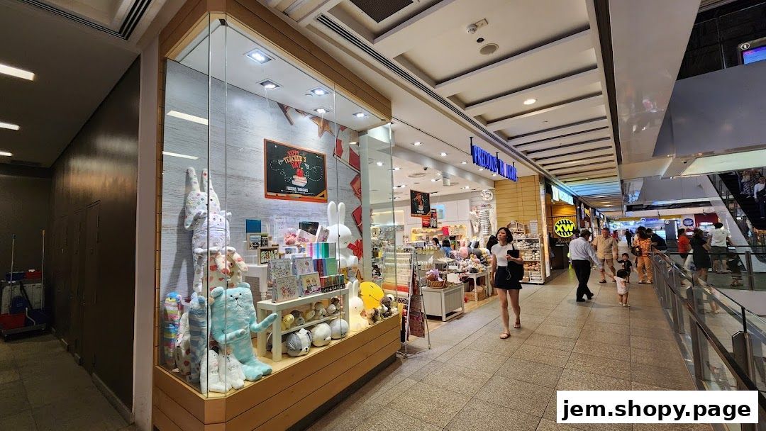 A brightly lit shop front displaying plush toys, stationery, and gifts, with shoppers passing by.