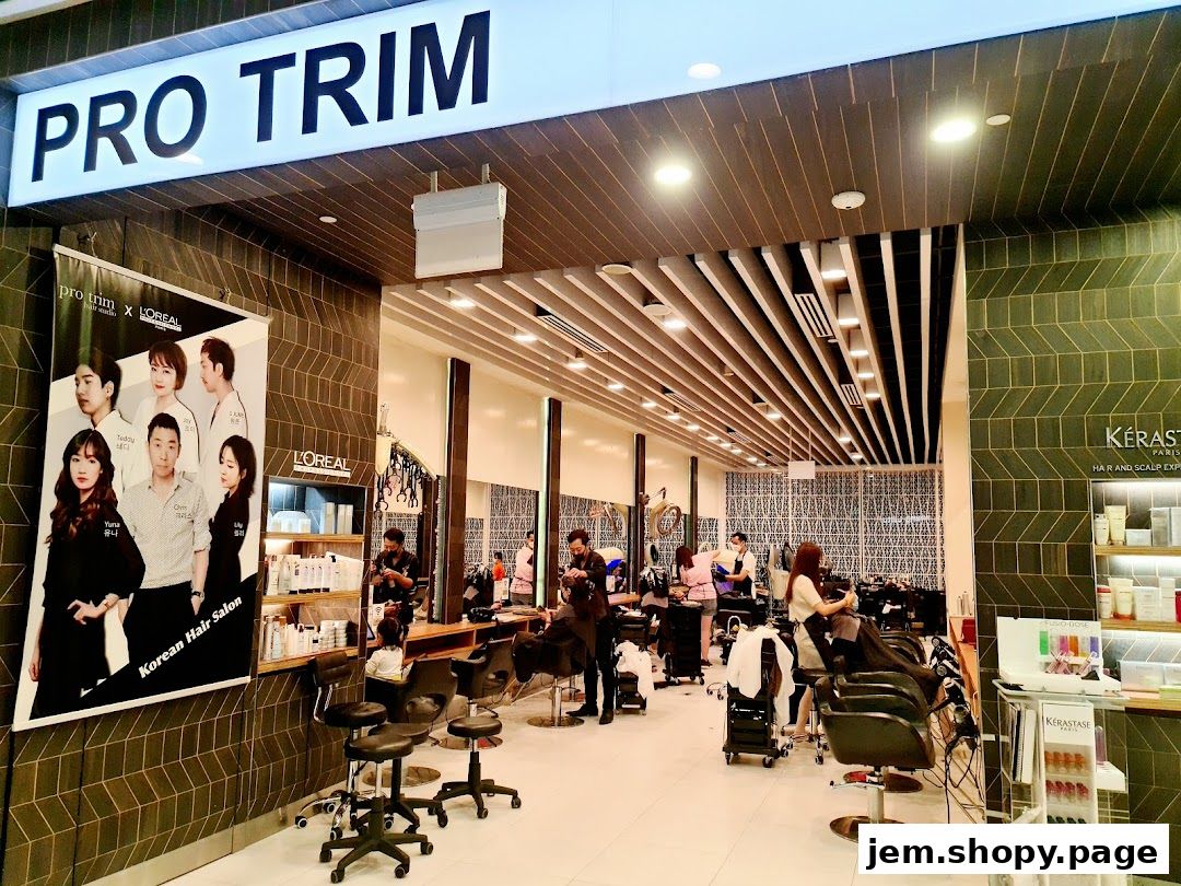 Interior view of Pro Trim Hair Salon, showcasing stylists at work and L'Oreal and Kerastase products.