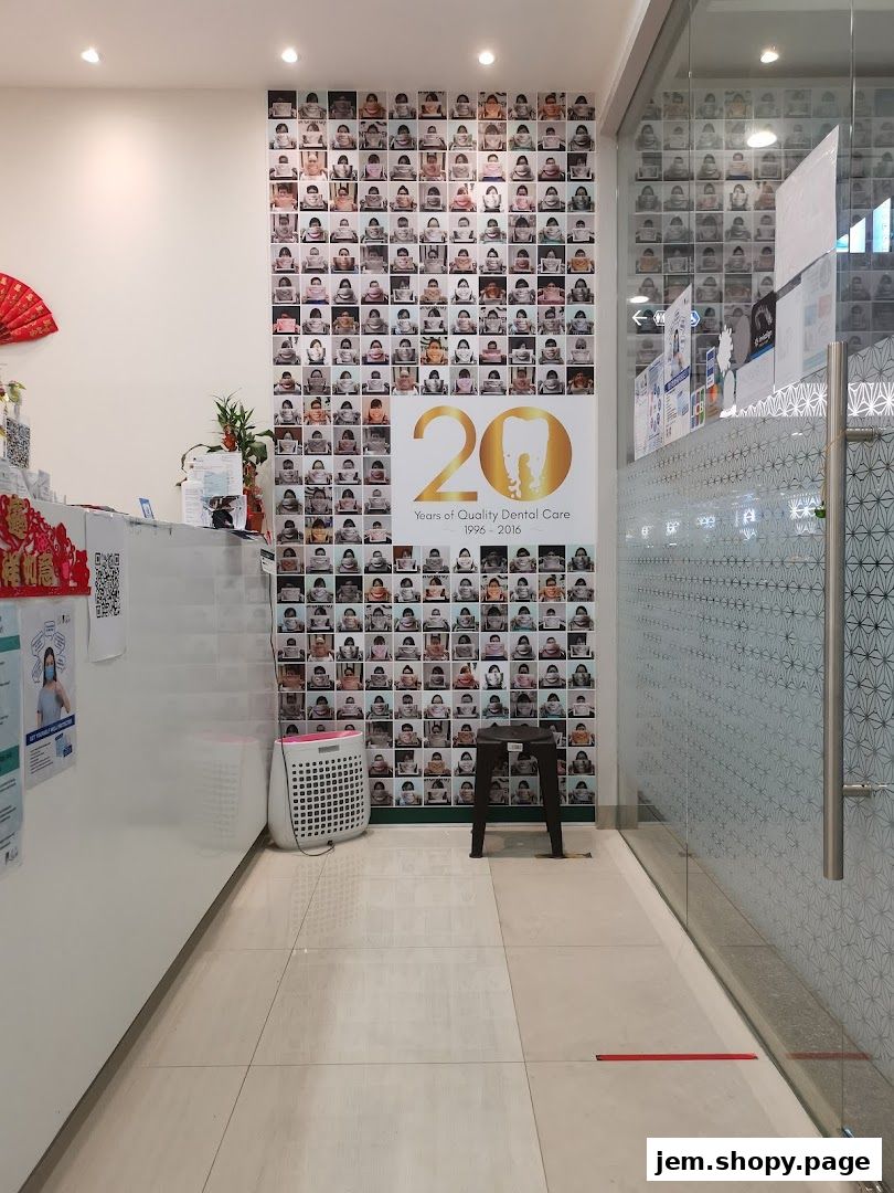 Interior view of a dental clinic with a wall displaying photos and a 20th-anniversary logo.