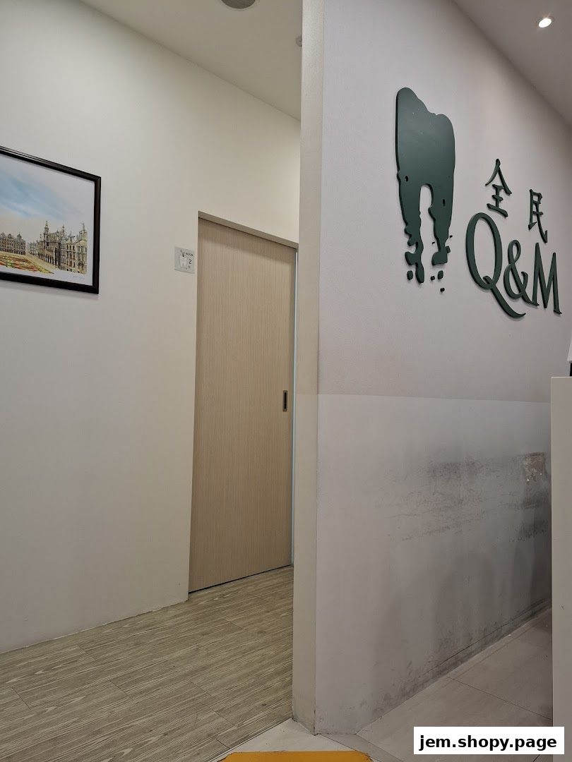 Interior view of a dental clinic hallway with a door and clinic branding on the wall.