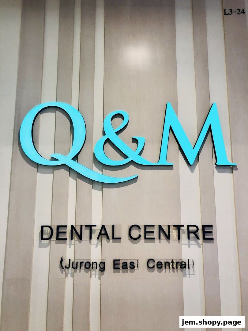The entrance sign for Q & M Dental Centre at Jurong East Central.