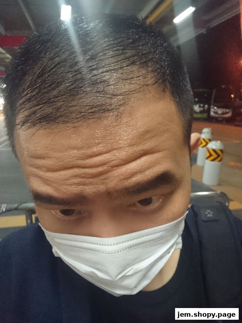 A close-up of a person wearing a face mask, with a blurred background.