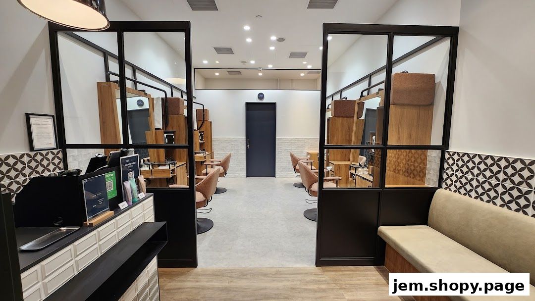 Interior view of a modern hair salon with styling stations and a waiting area.