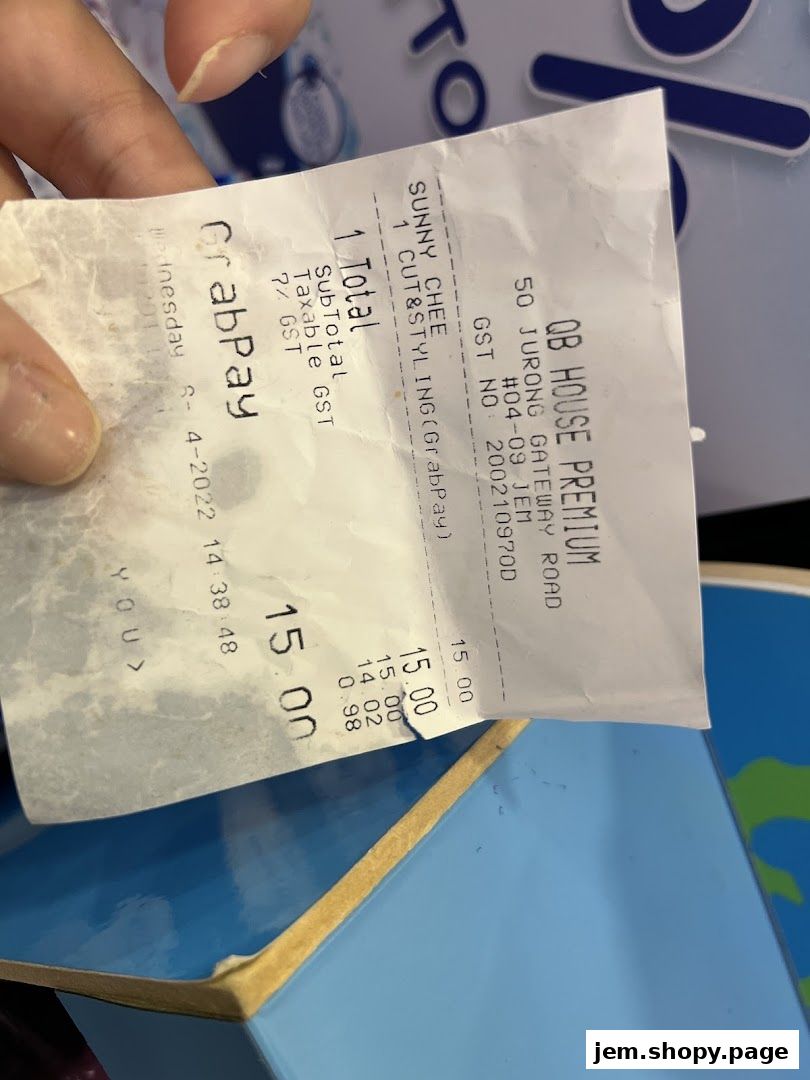 A receipt from QB House Premium showing a haircut and styling service.