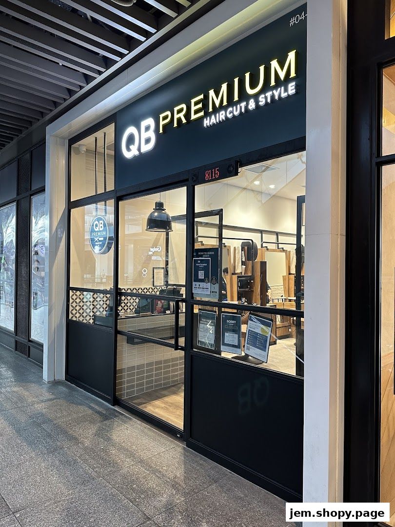 Exterior view of QB PREMIUM HAIR CUT & STYLE shop with a prominent sign and glass windows.