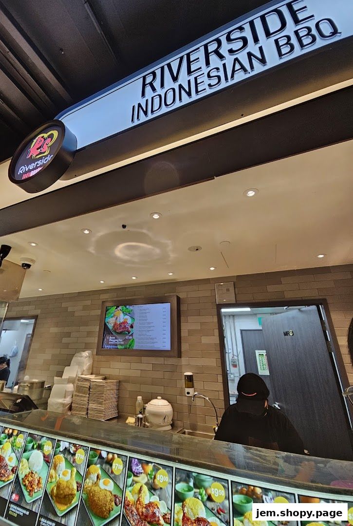 Interior view of Riverside Indonesian BBQ Jem with a digital menu and food display.