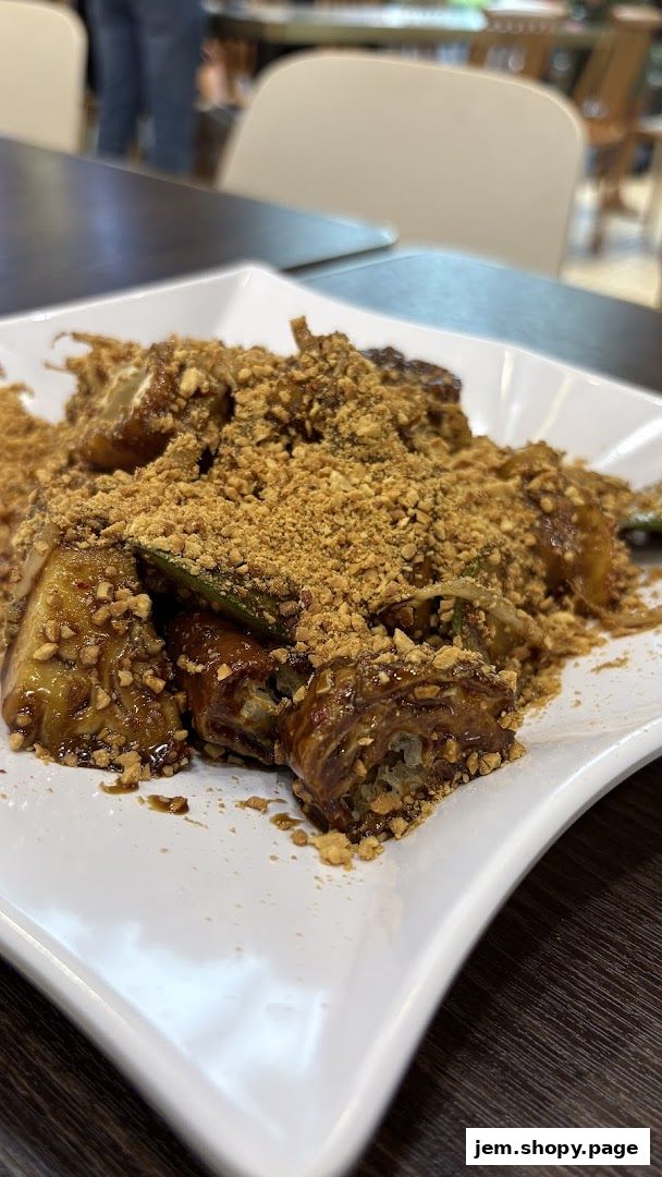 A close-up of a delicious Rojak dish topped with crushed peanuts.