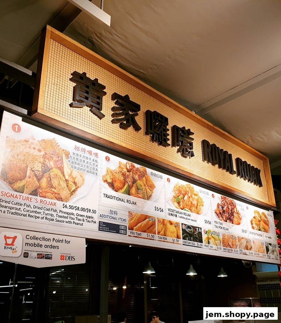 A food stall menu board displaying various Rojak dishes and additional items with prices.