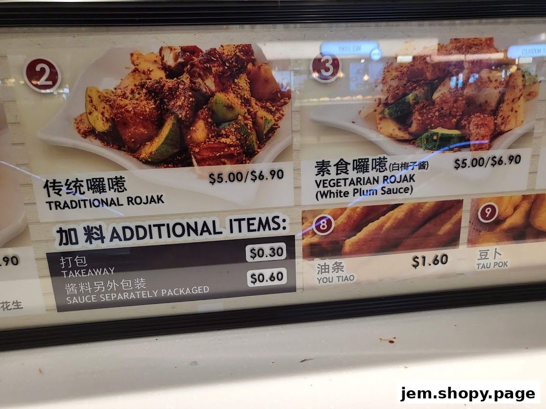 A menu display showing Traditional Rojak, Vegetarian Rojak, and additional items like takeaway packaging.