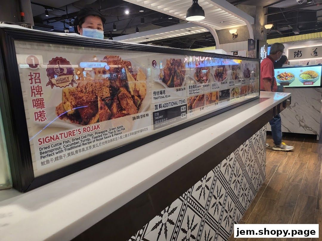 A display case showcasing signature rojak dishes with prices and descriptions.