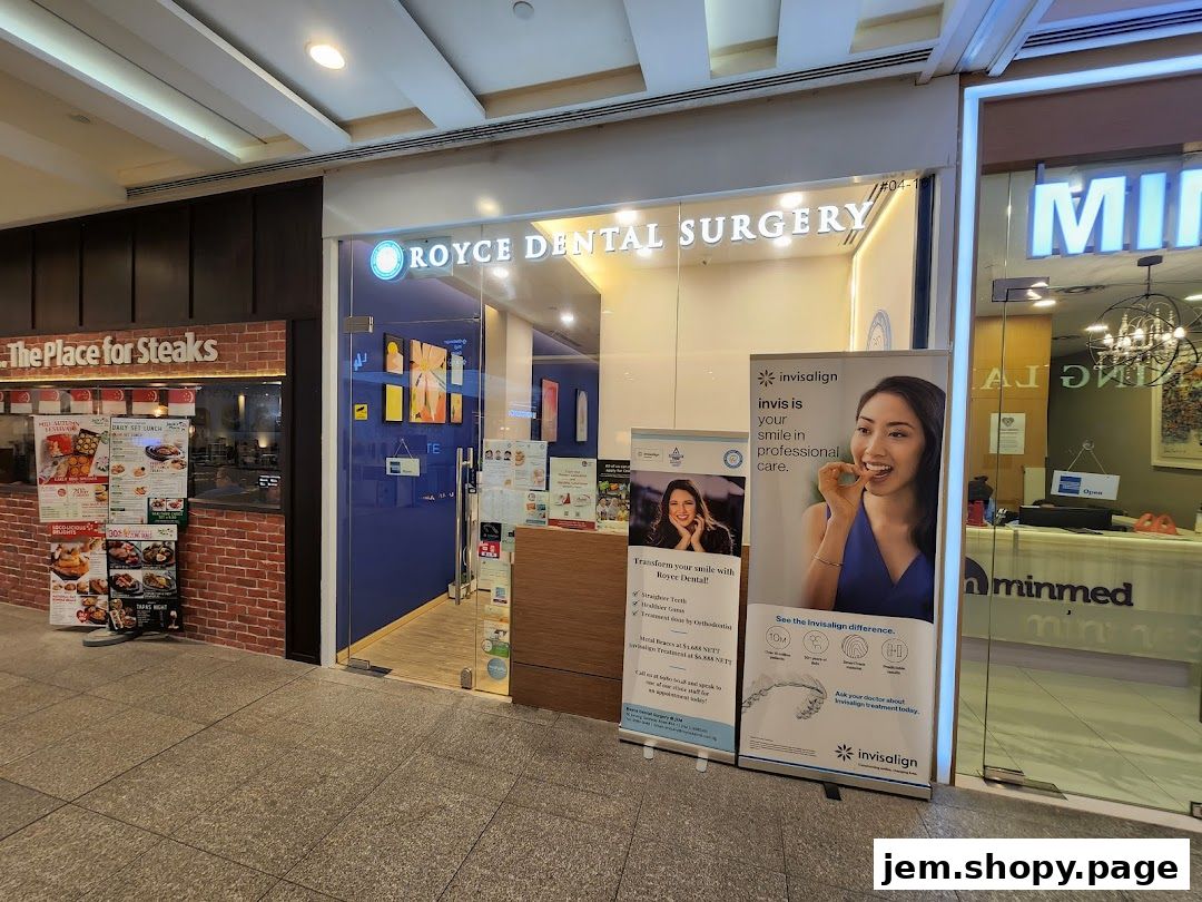 The exterior of Royce Dental Surgery, featuring a blue entrance and promotional banners for Invisalign.