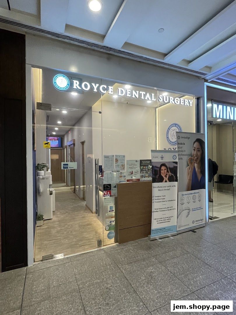 Exterior of Royce Dental Surgery, featuring a modern glass entrance and promotional posters.
