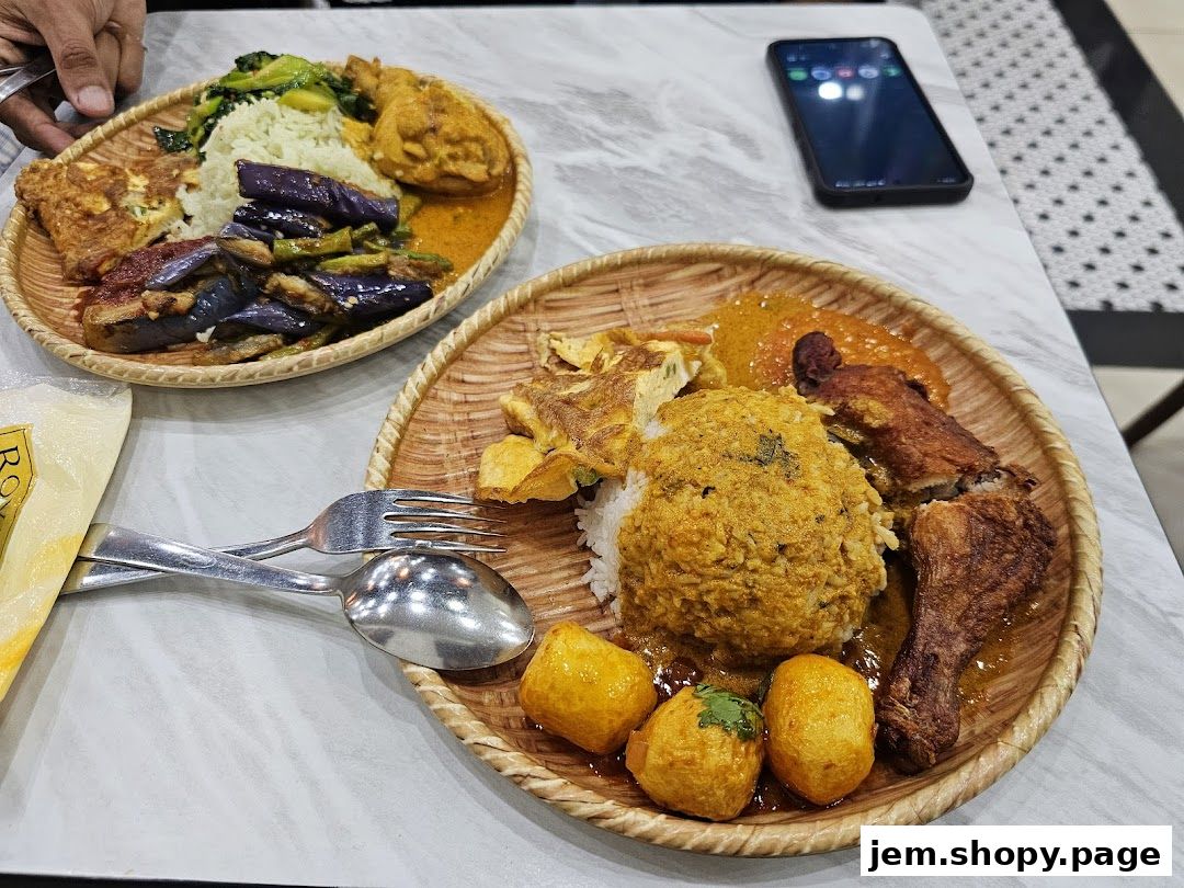 Two plates of rice with various side dishes, including fried chicken, vegetables, and curries.