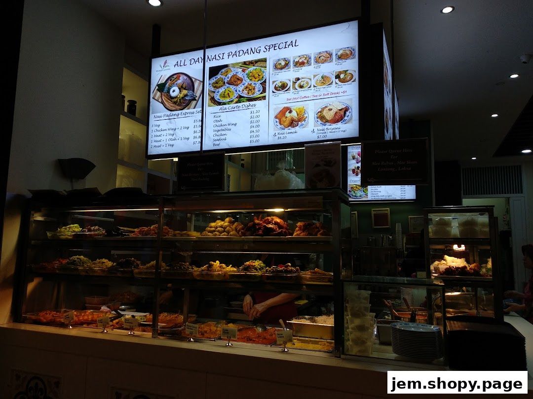 A brightly lit menu board displays Nasi Padang specials and ala carte dishes.