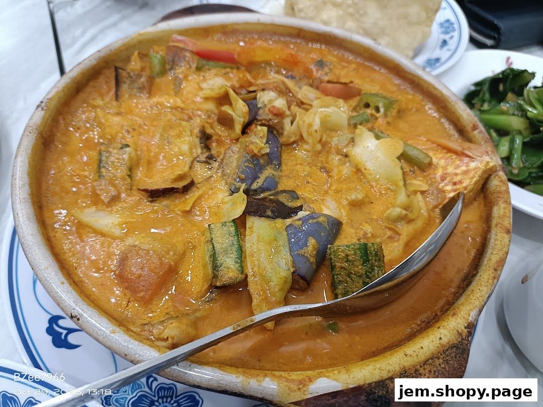 A close-up shot of a rich, creamy curry dish served in a rustic clay pot.