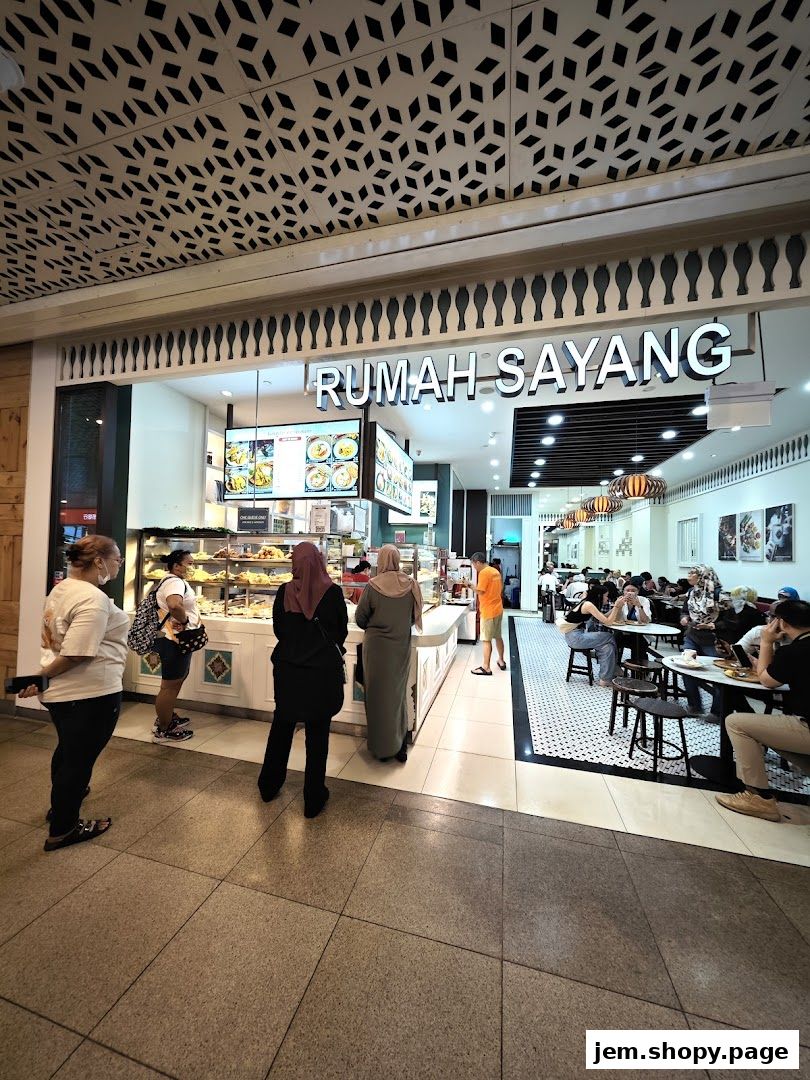 The entrance of Rumah Sayang, a food establishment with a display of food and seating area.