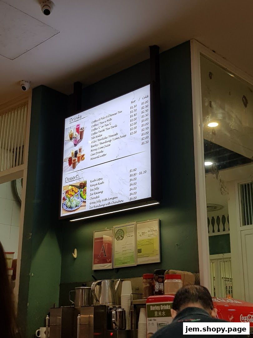 A menu board displaying drinks and desserts with prices at Rumah Sayang.