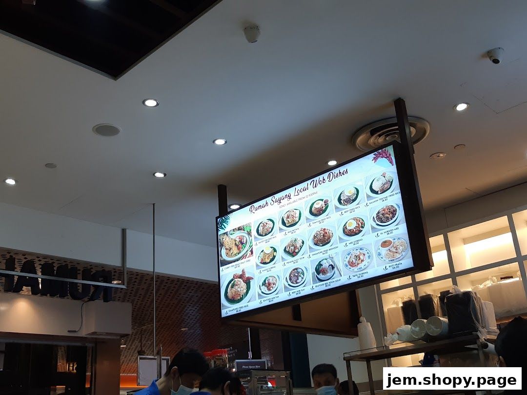 A digital menu board displaying local wok dishes from Rumah Sayang.