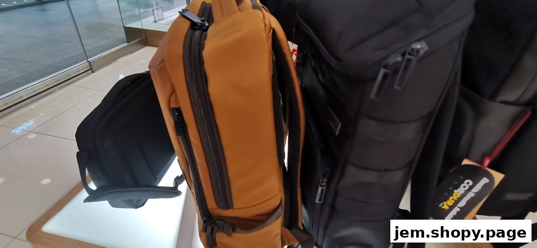 Close-up of various backpacks displayed in a retail store.