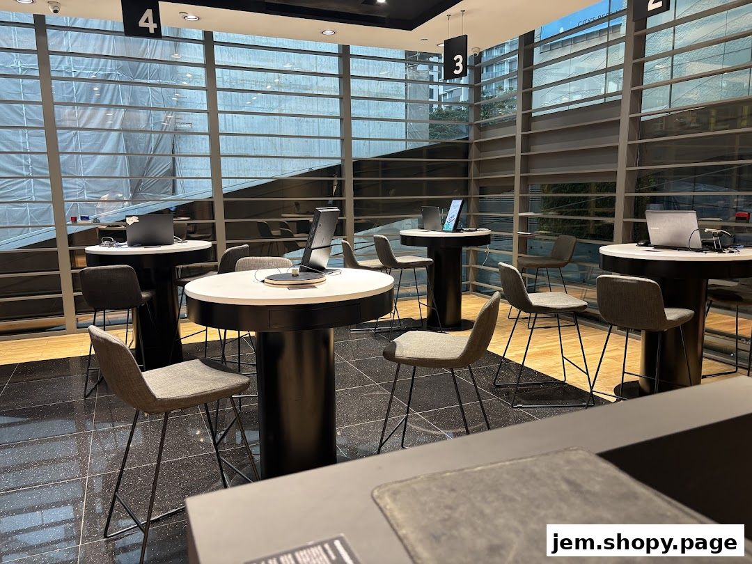 Interior of a Samsung Service Centre with tables, chairs, and laptops.
