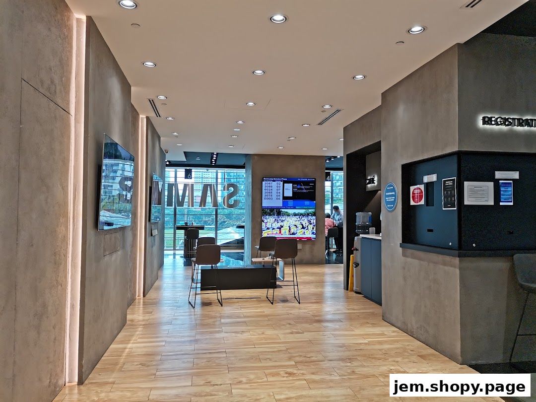 Interior of a modern Samsung Service Centre with digital displays and seating areas.