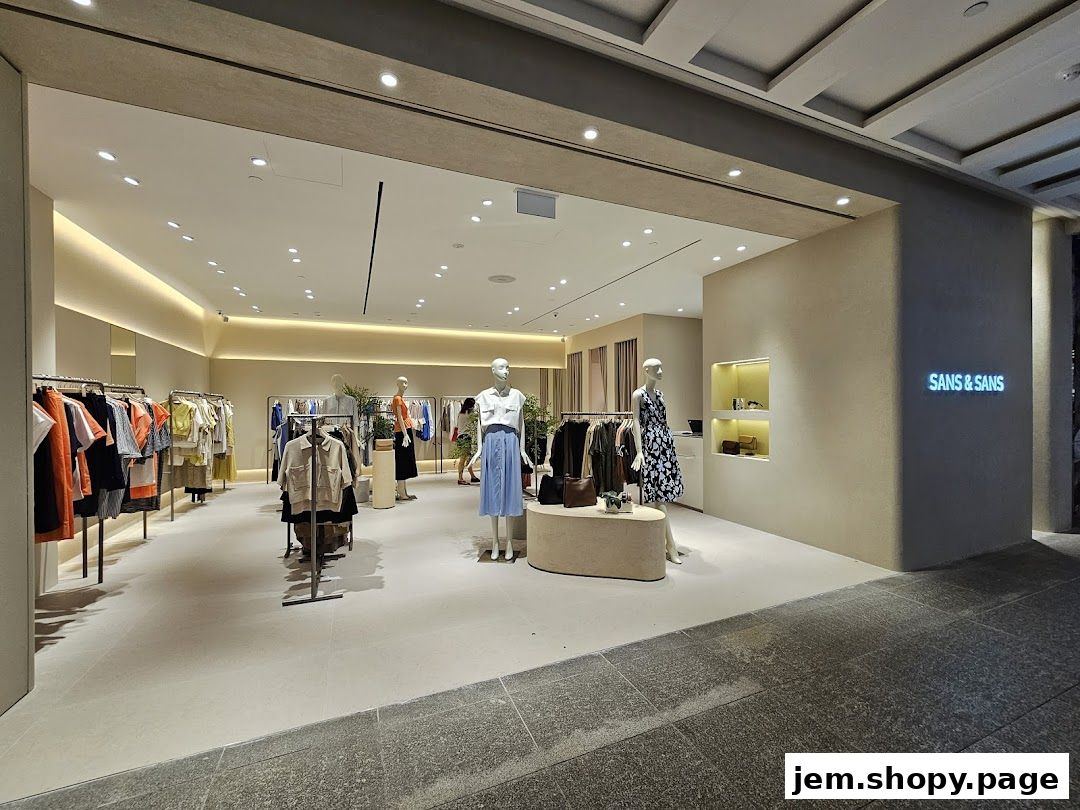 The entrance and interior of a modern clothing store, Sans & Sans, with mannequins and apparel on display.