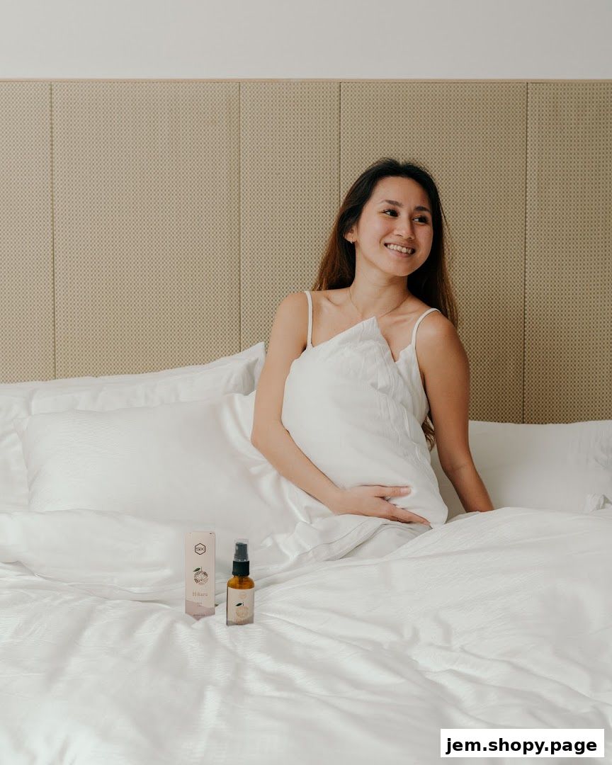 A woman smiles while sitting on a bed with a pillow and a product from Scent by SIX.