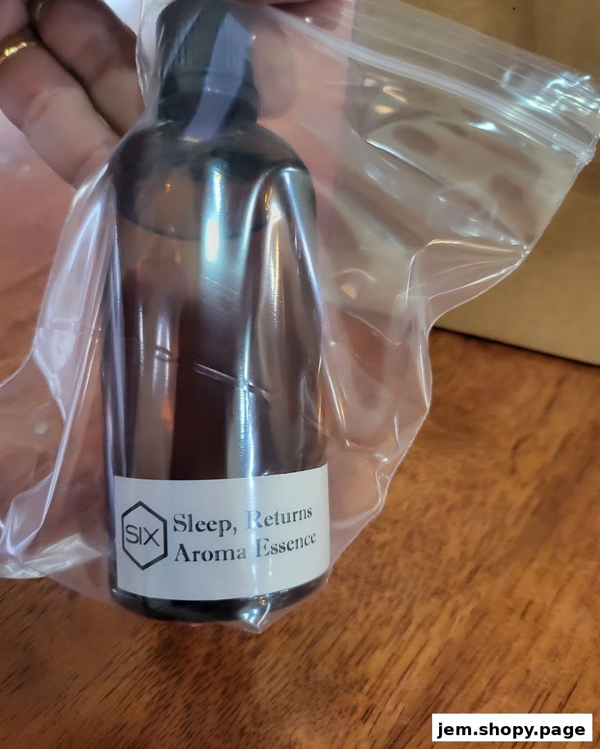 A hand holds a bottle of 'Sleep, Returns Aroma Essence' in a plastic bag.