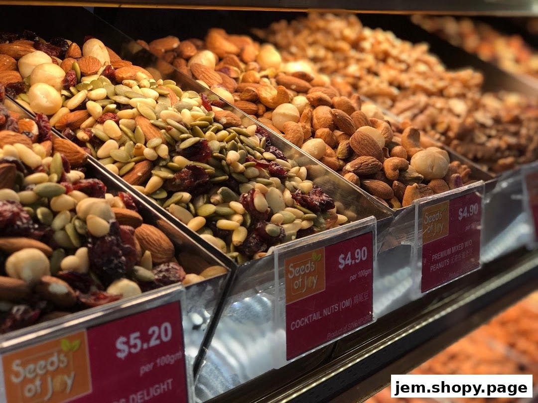 A display of various nuts and dried fruits in clear containers with price tags.