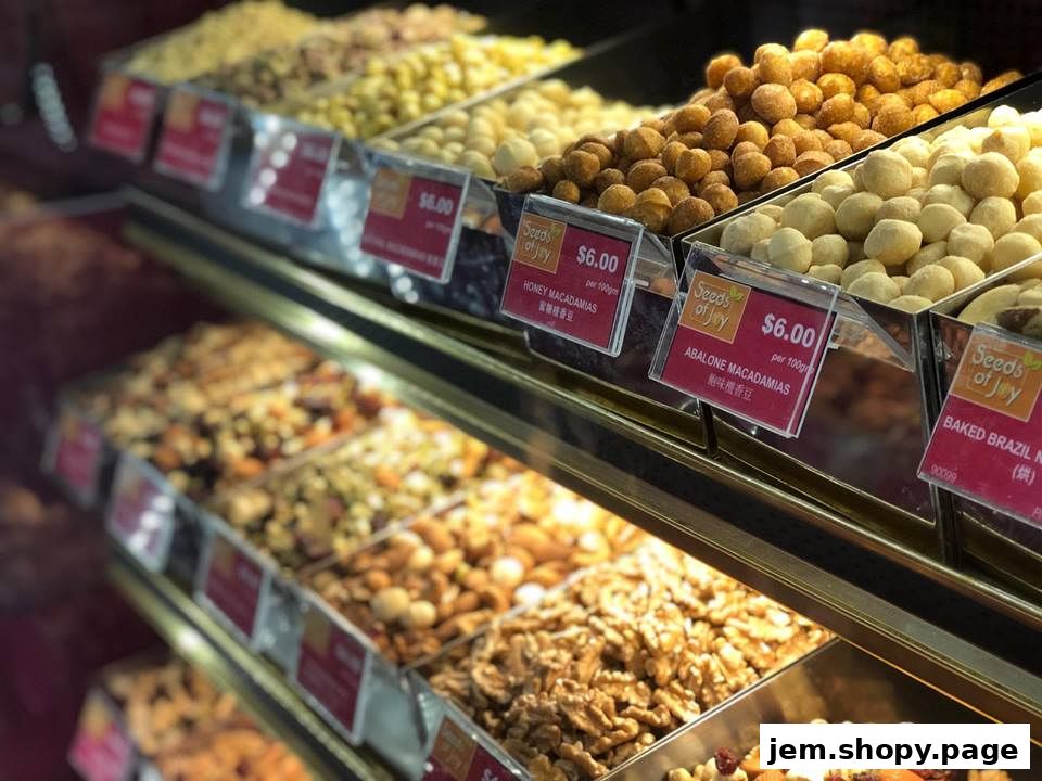 A display of various nuts and dried fruits in bins at a shop called Seeds of Joy.