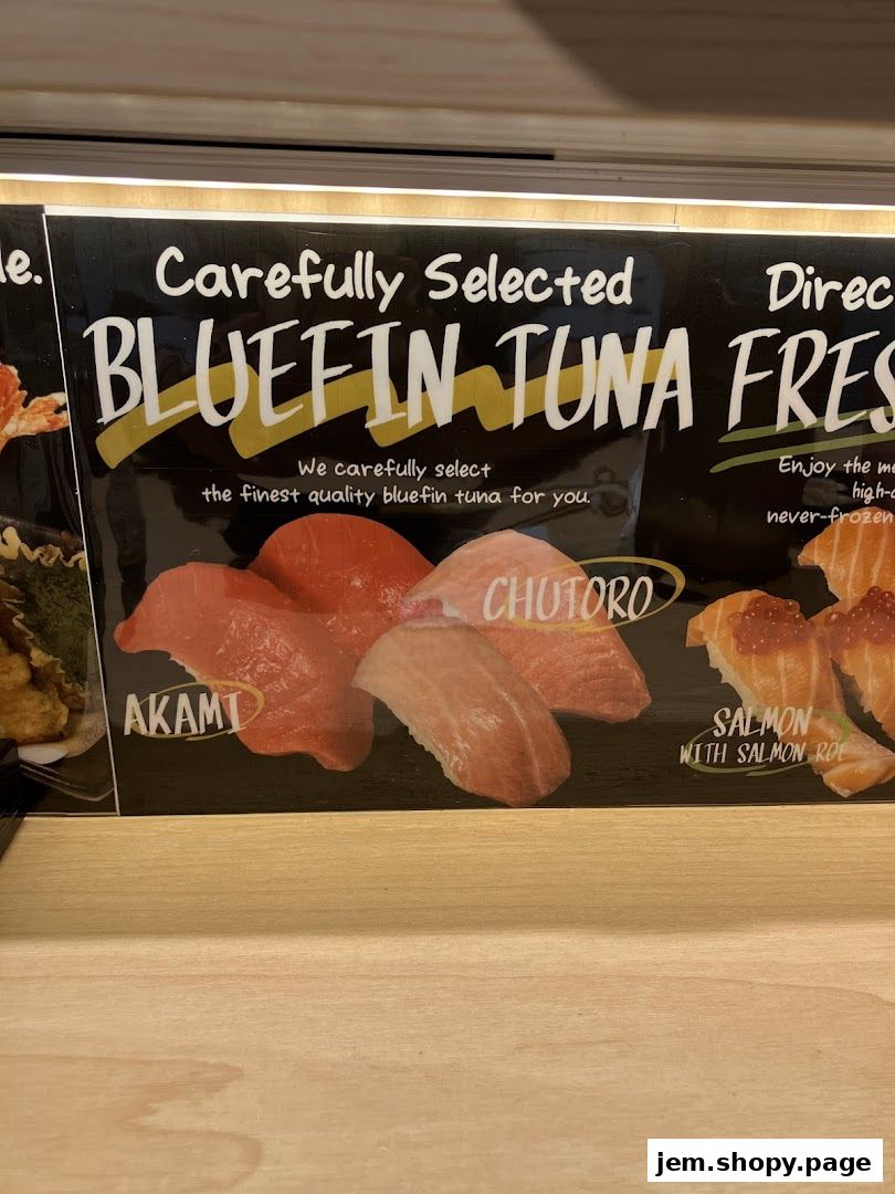 A display of fresh bluefin tuna and salmon sushi with labels.