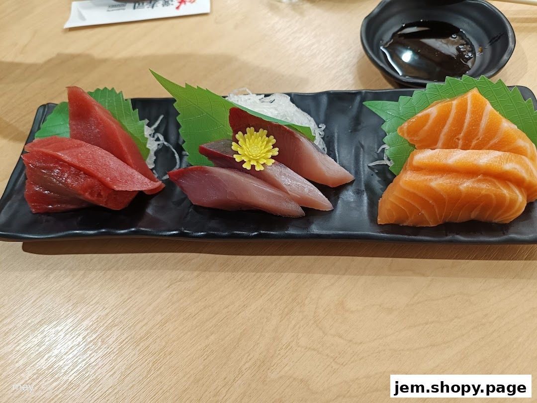 A platter of fresh tuna and salmon sashimi served with soy sauce.