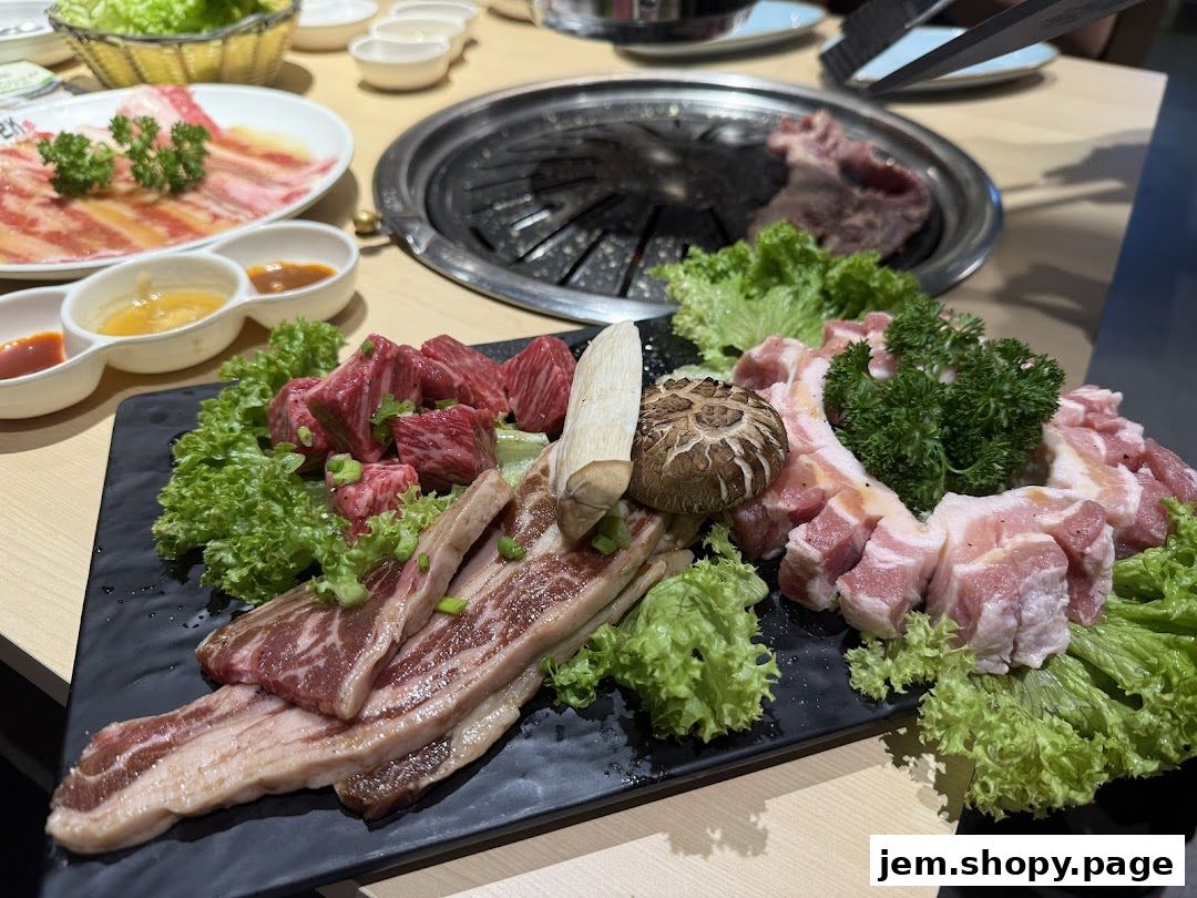 A platter of raw meats, including beef and pork belly, with lettuce and sauces.