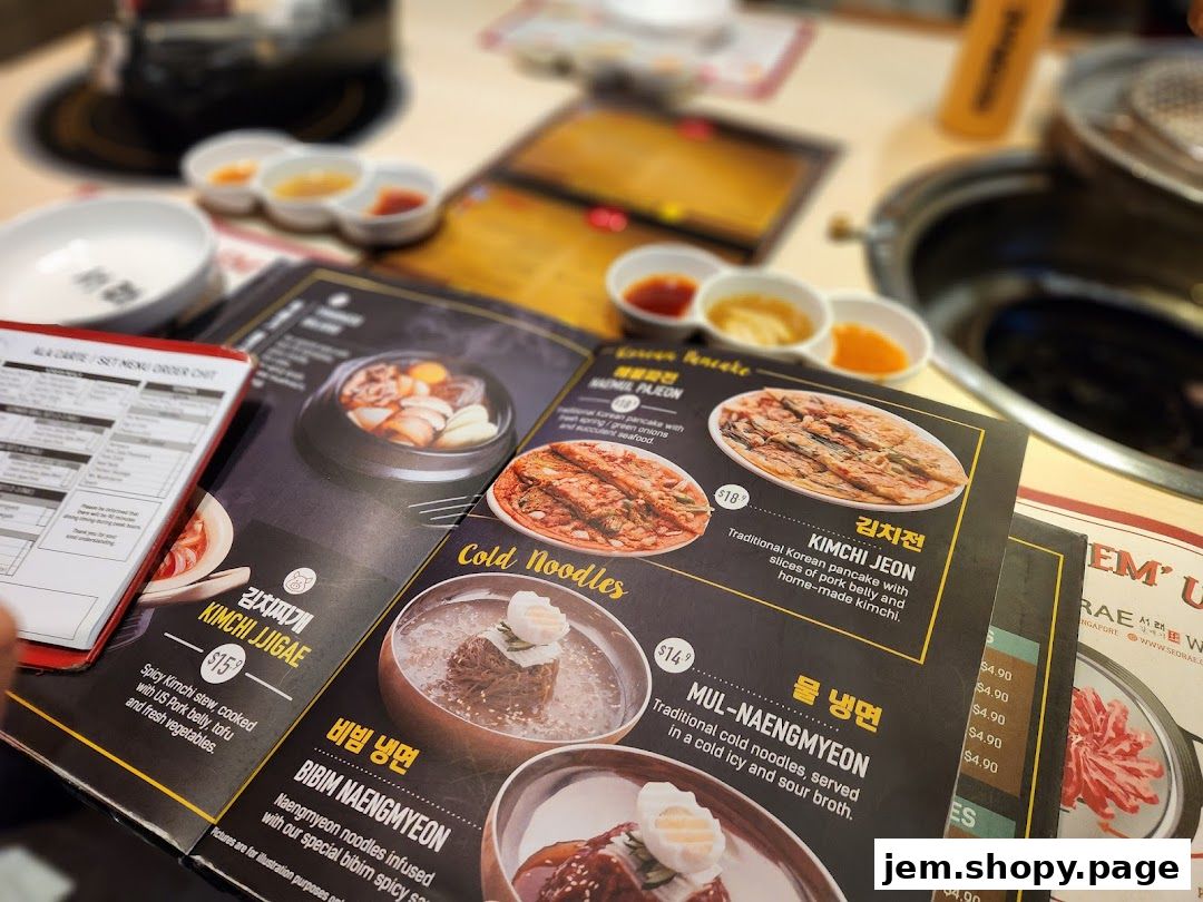 A menu from SEORAE JIB JEM featuring Korean dishes like Kimchi Jjigae and cold noodles.