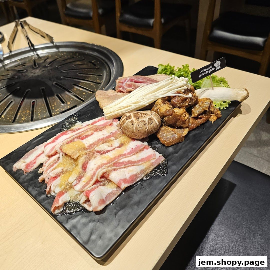 A platter of raw meats, mushrooms, and enoki mushrooms ready for grilling.